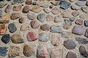 Old round pave stones as a fragment of an ancient street