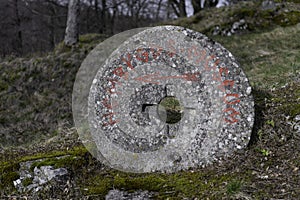 An old round stone with inscription.