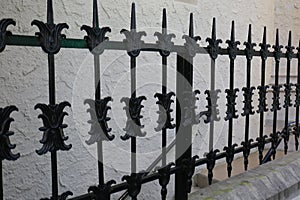 Old Rout Iron Fence with Textured Stucco Wall