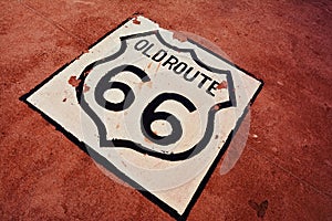 Old Route 66 sign on the asphalt.