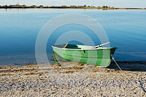 Old row boat on the beach. Sunrise.