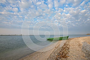 Old row boat on the coastline. Wide angle.