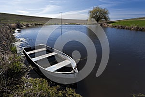 Old row boat in a small pond.