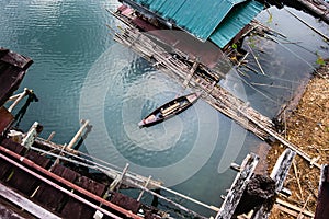 Old rowboat floating and anchoring