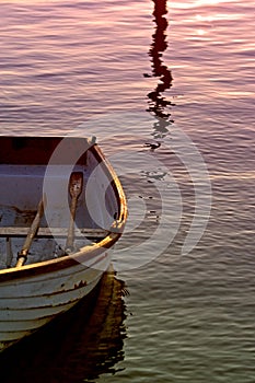 Old Rowing Boat with Oars on Sea During Sunset