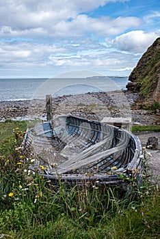 Old rowing boat on the pebble beach in Cornwall