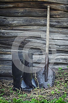Old rubber boots and shovel