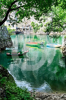 Old rugged and colorful boats docked in the small lake bay