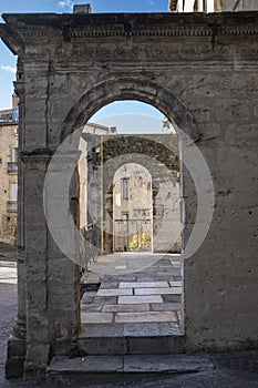 Old ruin arch entrance perspective in a medieval scene in Montpellier, France