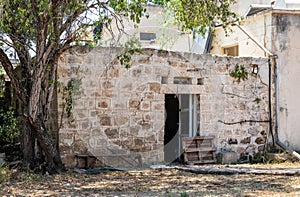 Old ruined abandoned stone building on one of the quiet side streets near the main pedestrian HaMeyasdim in Zikhron Yaakov city
