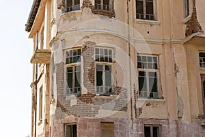 Old ruined abandoned yellow and highrise building in Ankara Turkey