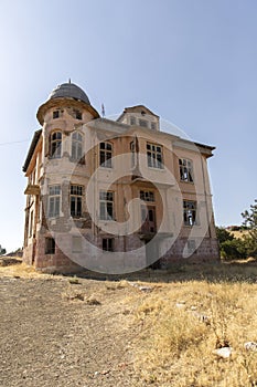 Old ruined abandoned yellow and highrise building in Ankara Turkey