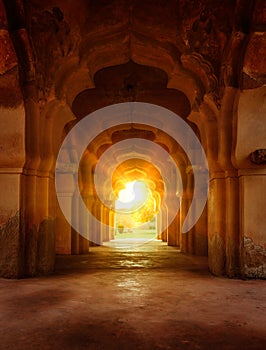 Old ruined arch in ancient palace at sunset