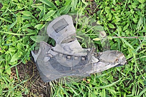 Old ruined brogue shoe in the grass