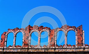 Old ruined building  against the blue sky.  Destroyed ancient architecture. Historical remains