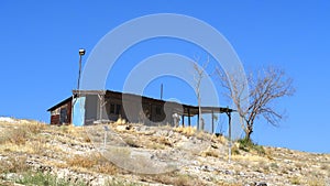 Old ruined house on a hill under the sunlight and a blue sky in Nallihan, Turkey
