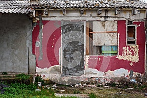 Old ruined house in slum with deteriorated facade