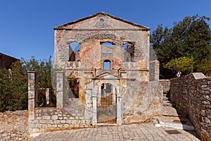 Old ruined house on a traditional street in the Greek village of Symi.