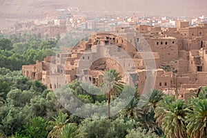 Old ruined Moroccan Kasbah among palmtrees