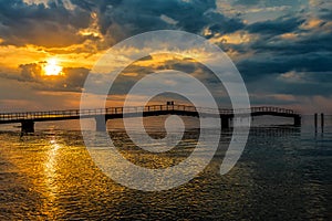 Old ruined pier at sunset