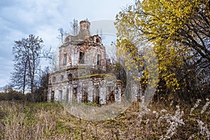 An old ruined red brick church on an autumn cloudy day