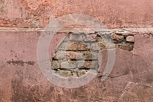 Old ruined stone facade of an abandoned building ancient architecture