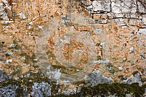 Old ruined stone wall with moss