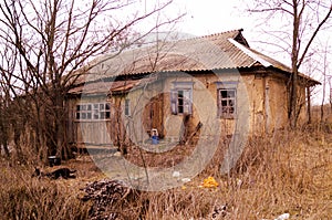 Old ruined village house. Abandoned rural yard.