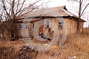 Old ruined village house. Abandoned rural yard.