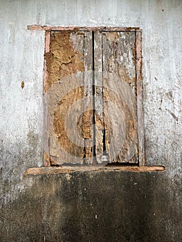 Old ruined window on grungy white wall
