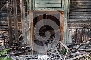 Old ruined wooden house. Two-story building intended for demolition.