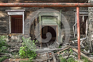 Old ruined wooden house. Two-story building intended for demolition.