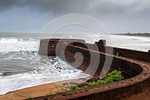 Old ruins of Fort Aguada on the seashores of Goa with sky and clouds photo