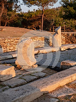 Old ruins and stones carved in the old greek language at the archeological site near Aliki Marble Port on Thasos Island, Greece