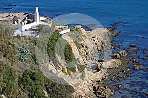 Old run down building next to sea