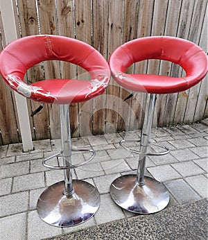 old rundown bar counter red stool which needs repair