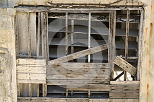 An old rundown warehouse wall built of wood and cement