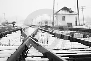 Old, rural railroads and railway station in winter