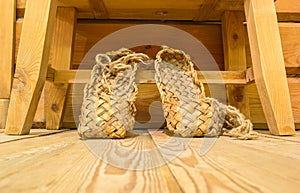 Old russian bast shoes on wooden floor