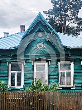An old Russian hut with carved platbands. Blue mint house