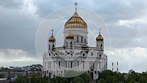 Old Russian Orthodox church with golden cupolas in city
