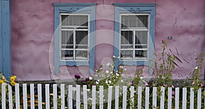 Old Russian Pink Log Cabin with White Fence