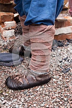 Old Russian sandals on his feet