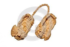 Old Russian sandals made from bast on a white background