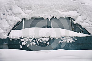 Old russian soviet car buried under the snow