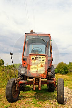 Old Russian tractor in the yard of a farm