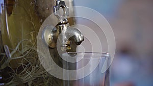 Old Russian traditional copper samovar. Art. Closeup of the faucet of the samovar. Metal tap of samovar closeup