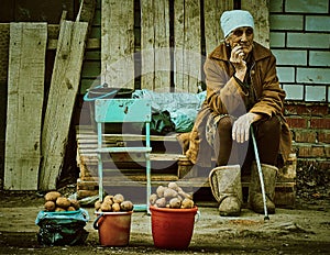 Old Russian woman selling potatoes Kaluga region.