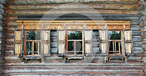 Old russian wooden house with decorated windows