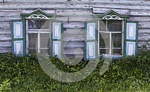 Old Russian Wooden Log Cabin with Green Shutters